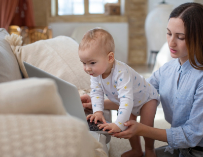 Baby caregiver caring for infant at home in Dubai with nurturing support